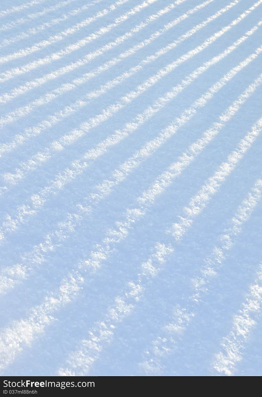 Shade from a picket fencing on fresh snow. Shade from a picket fencing on fresh snow