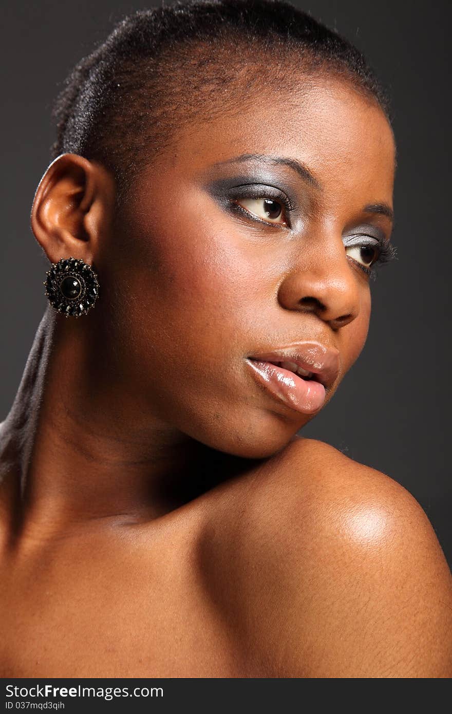 Portrait of moody, beautiful black woman with eyes looking away. Portrait of moody, beautiful black woman with eyes looking away.