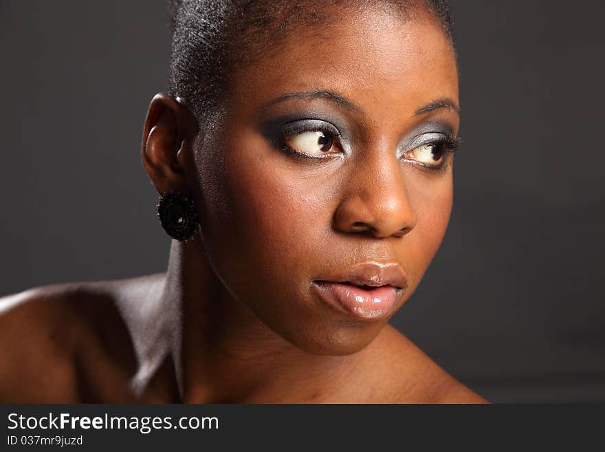 Landscape portrait of stunning, beautiful black woman looking away. Landscape portrait of stunning, beautiful black woman looking away.