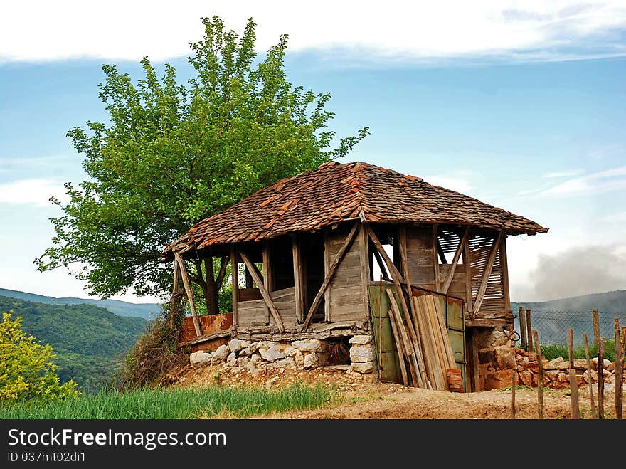 Old empty ruined house barrack on mountain