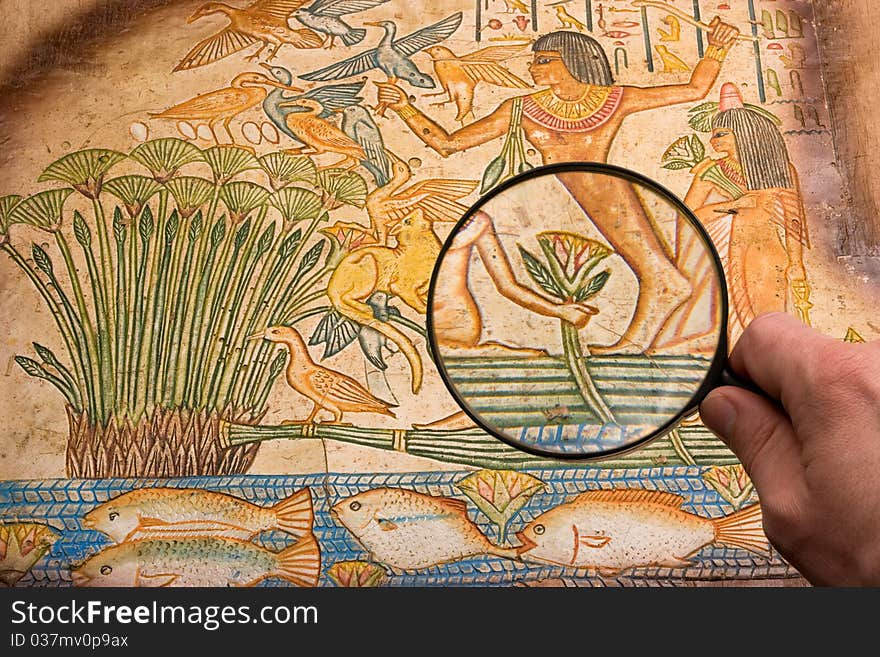 Magnifying glass on antique papyrus