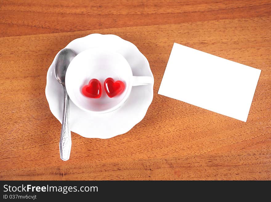 Coffee cup and heart on a brown background