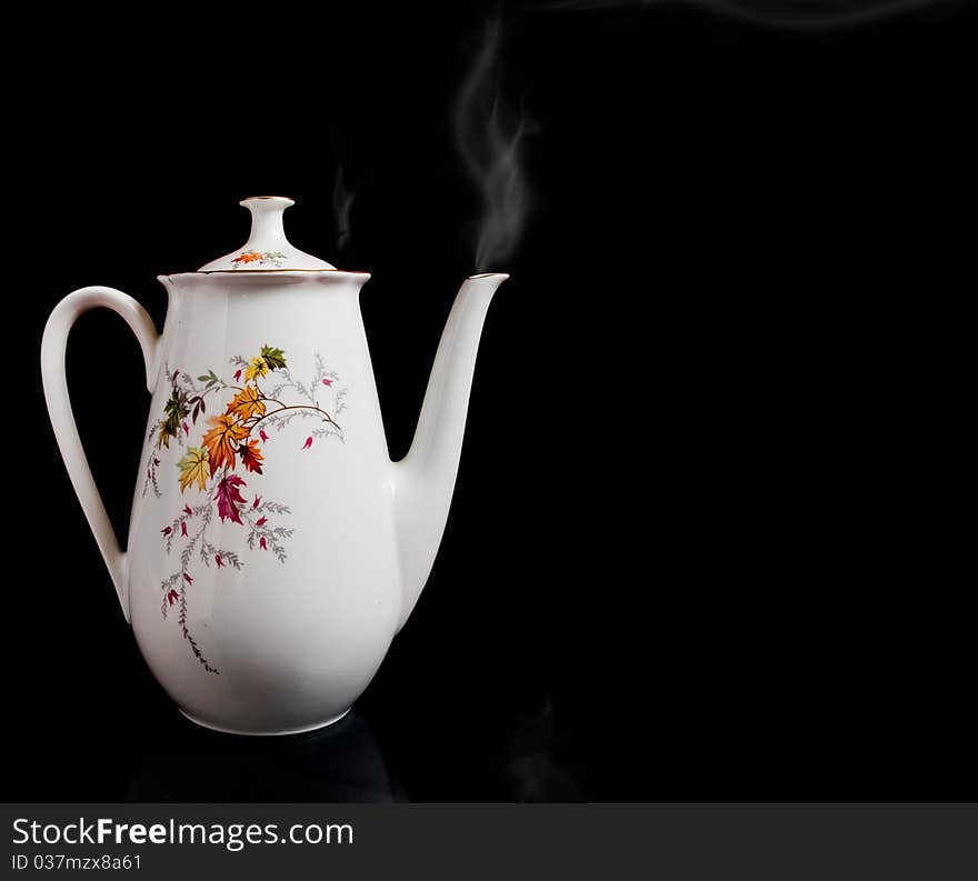 Big white kettle with pair or smoke isolated on black - lit a soft. Big white kettle with pair or smoke isolated on black - lit a soft