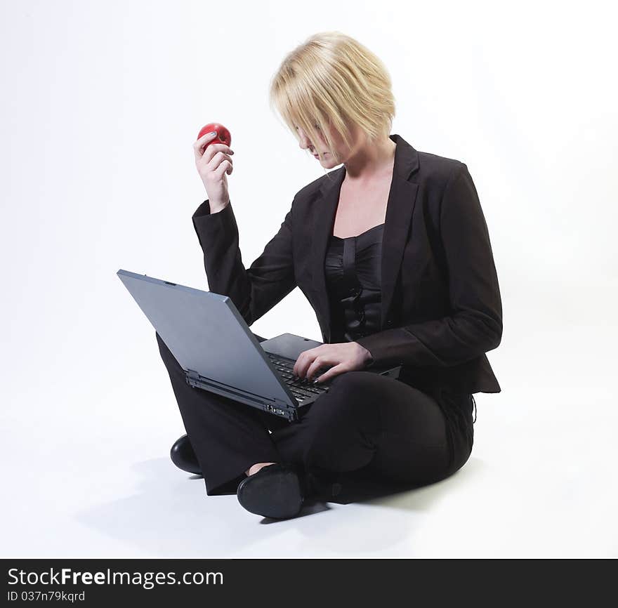 Businesswomans sitting with laptop and apple. Businesswomans sitting with laptop and apple