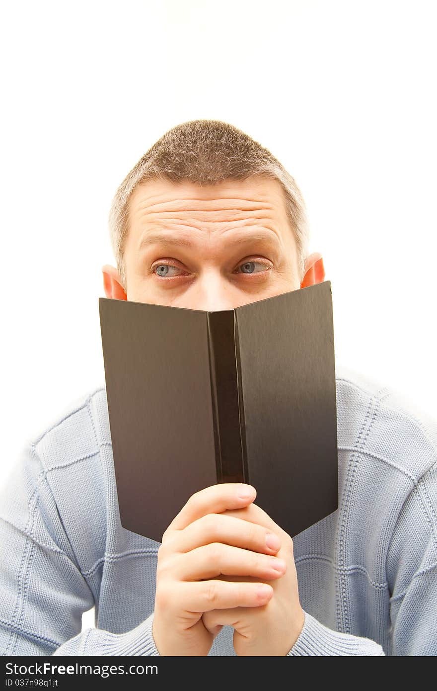 Man looking up behind a book