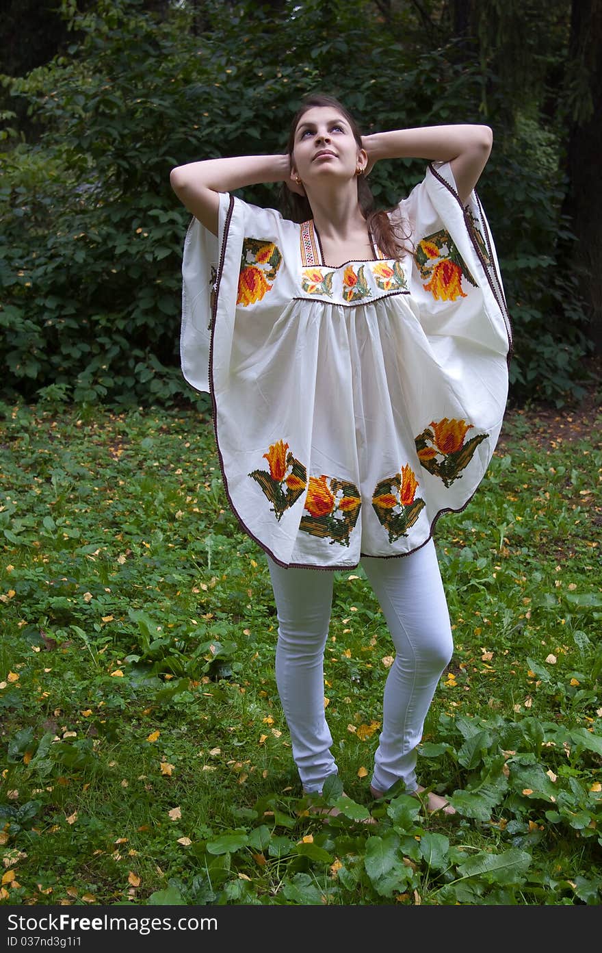 Girl in ethnic clothes outdoor in the park