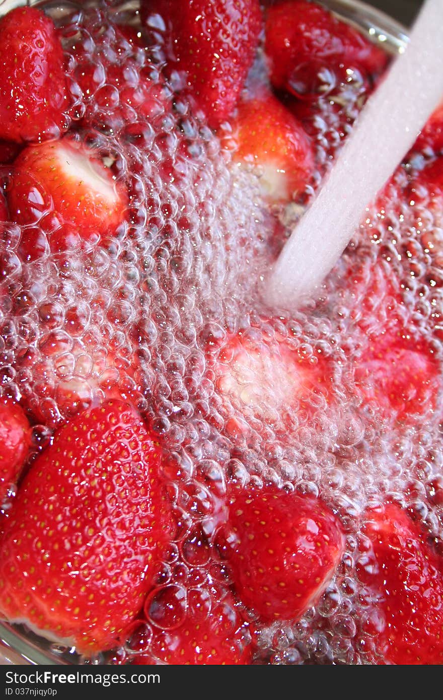 Fresh strawberries in a spray of water