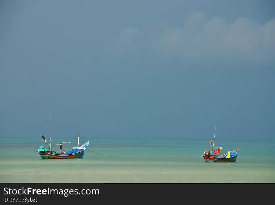 Two longtail boat in the sea very clear sky