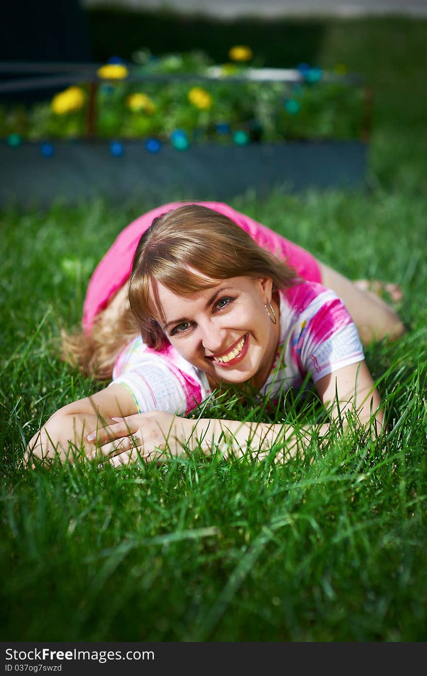 Joyful Young Woman On Grass