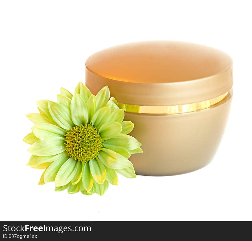 Container of cream and fresh green daisy flower isolated.