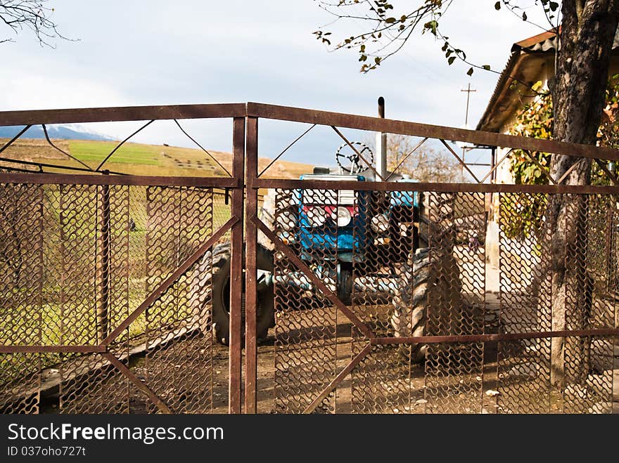 Blue tractor in the home yard in Carpathian village, Ukraine. Blue tractor in the home yard in Carpathian village, Ukraine