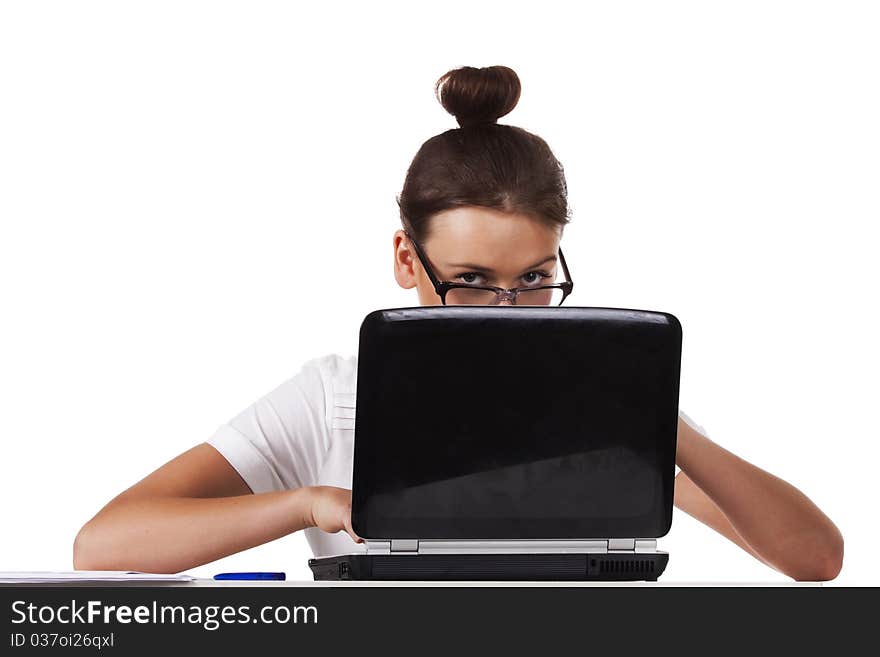 Woman with glasses sits at a table looks out from for the laptop and working on laptop A series of office work. Woman with glasses sits at a table looks out from for the laptop and working on laptop A series of office work