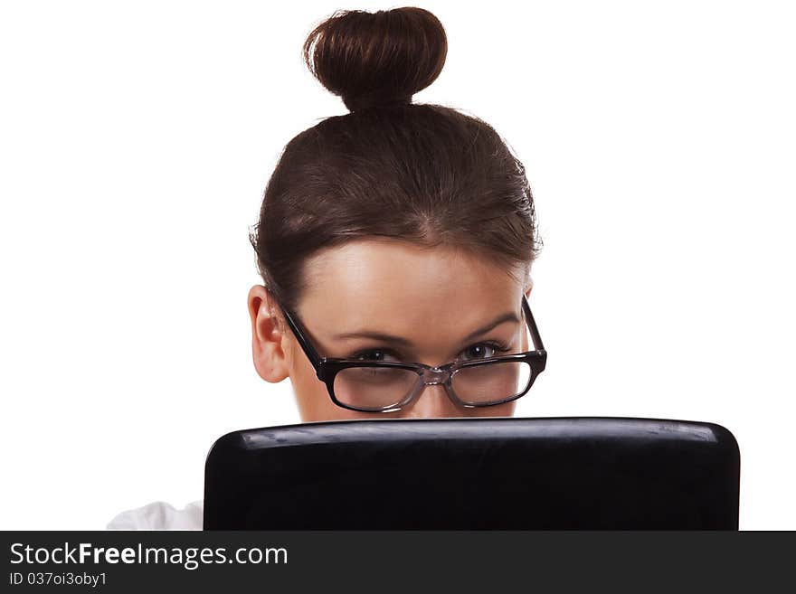 Woman with glasses sits and working on laptop