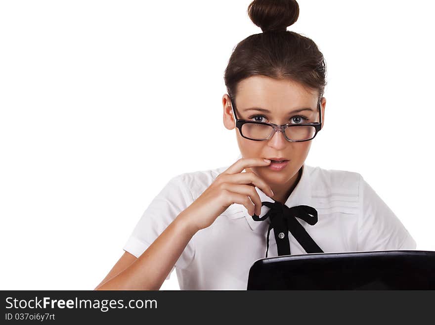 Woman with glasses sits and working on laptop