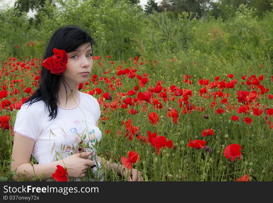 Young Black Hair Girl in red poppies field