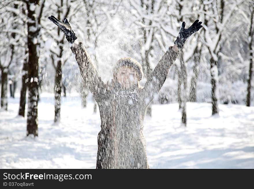 Beautiful young red-haired woman in winter park. Outdoor shot.