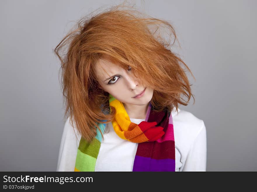 Red-haired rock girl in scarf. Studio shot.