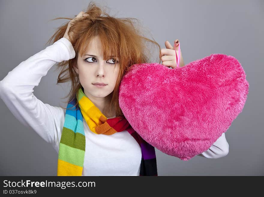 Sad girl with heart. St. Valentine Day. Studio shot.