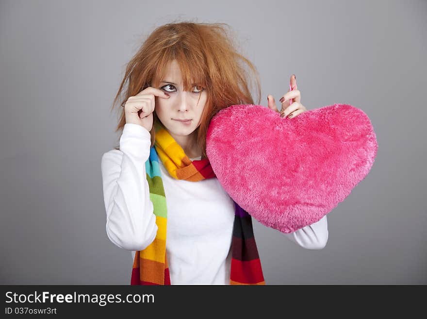 Sad girl with heart. St. Valentine Day. Studio shot.