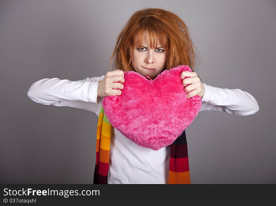 Sad girl with heart. St. Valentine Day. Studio shot.