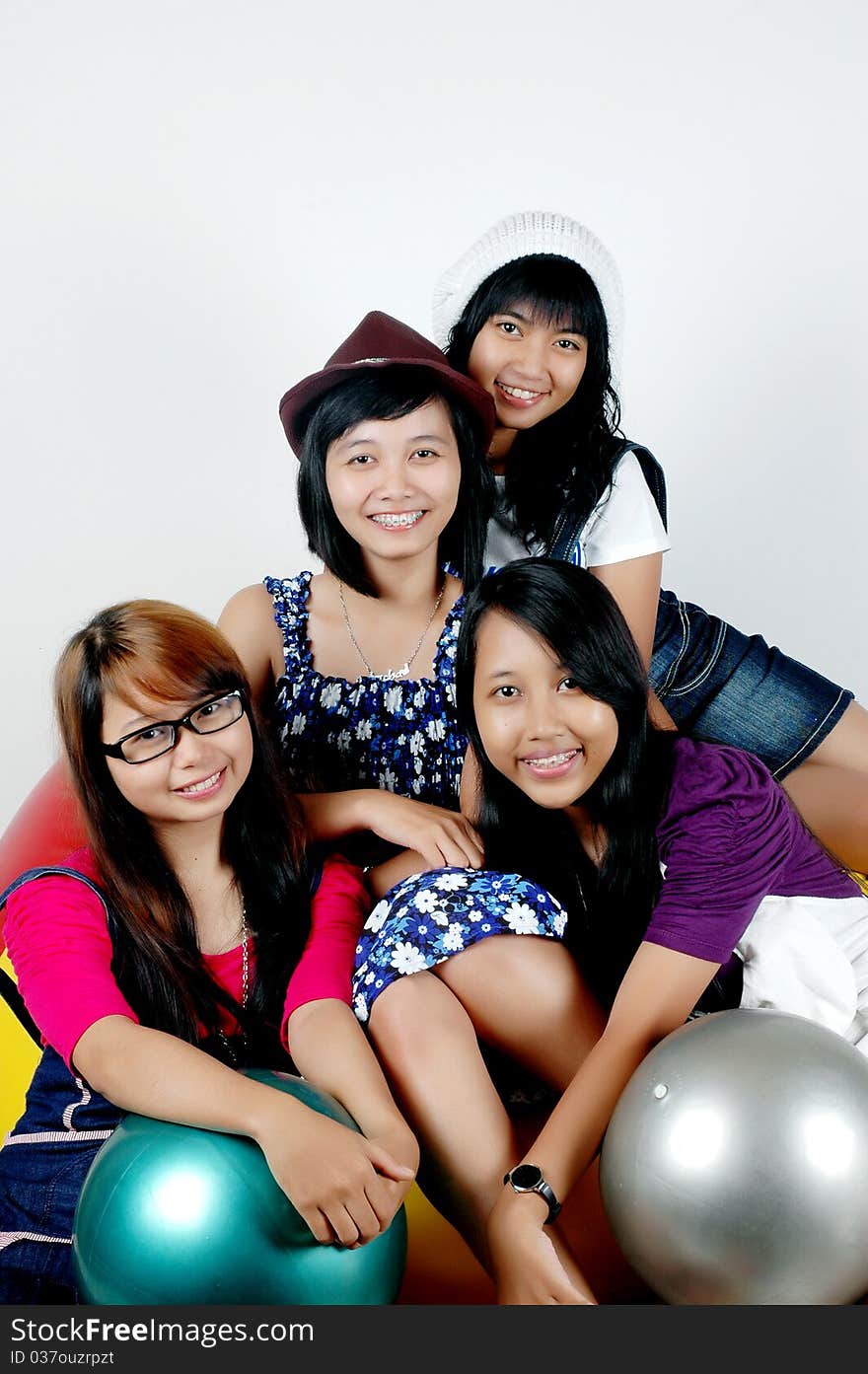 Four teens cheerful girls with photographed with a white background. Four teens cheerful girls with photographed with a white background