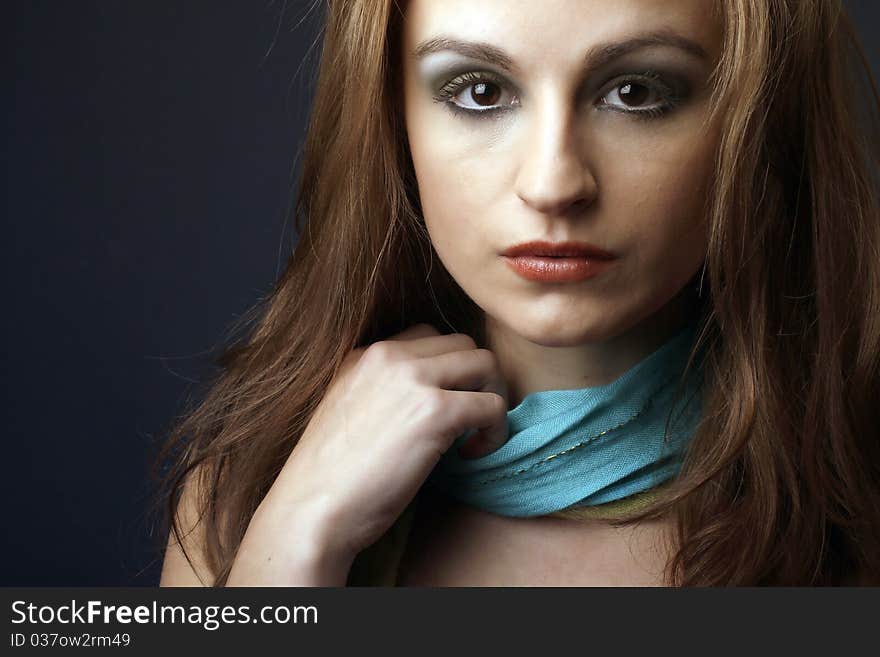 Closeup portrait of a red hair woman with blue scarf, studio shot. Closeup portrait of a red hair woman with blue scarf, studio shot