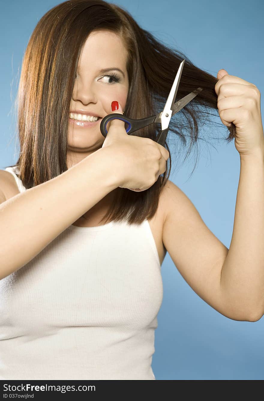 Beautiful brunette model cutting hair