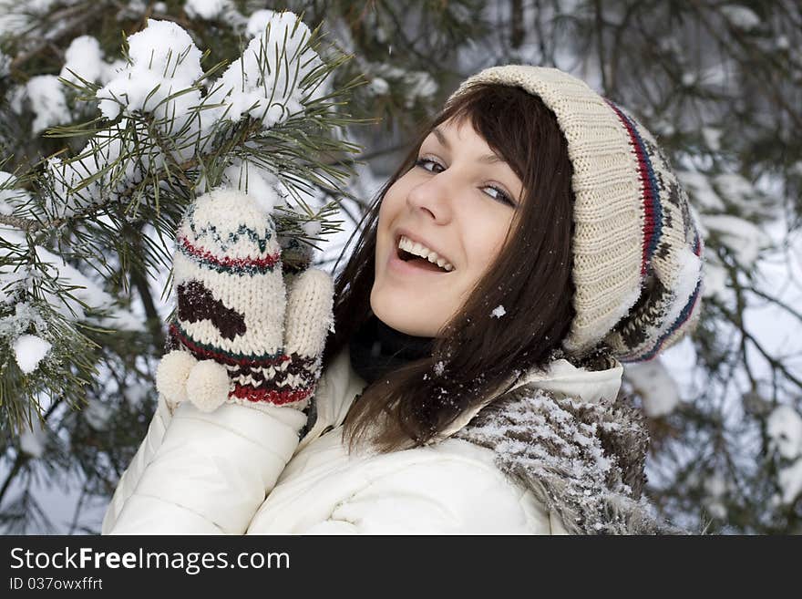 Cute girl standing near fir tree outdoor