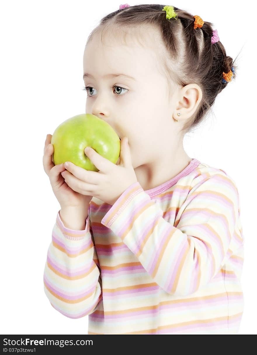 The child chewing an apple on a white background. The child chewing an apple on a white background