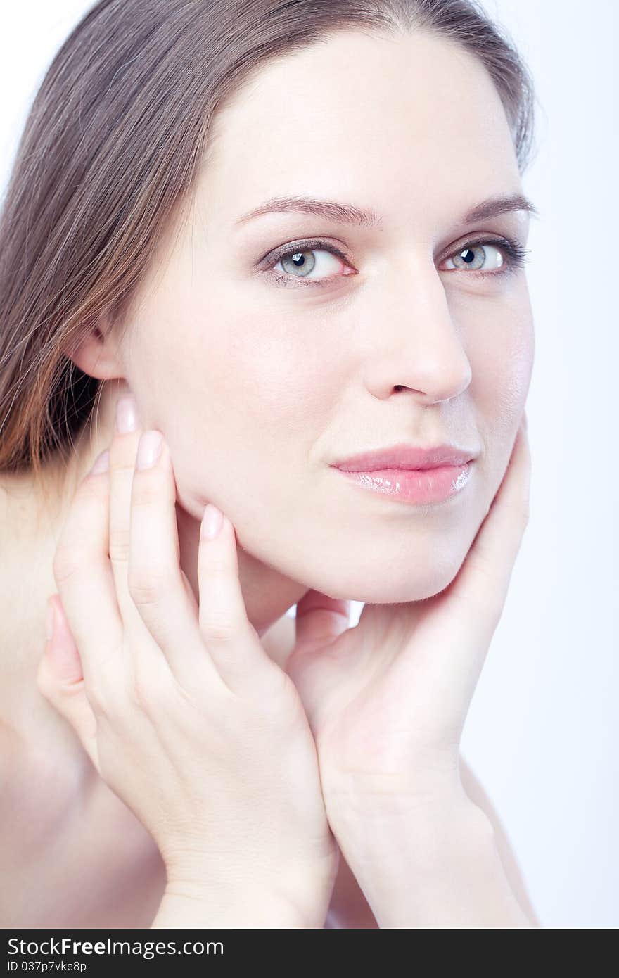 Young lady holding her face