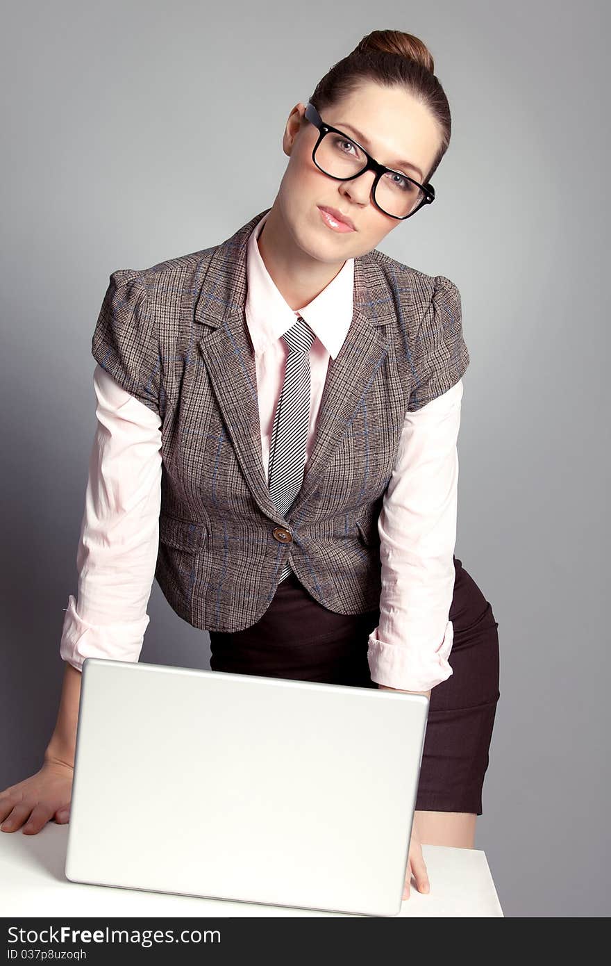 Cute business lady standing by the table