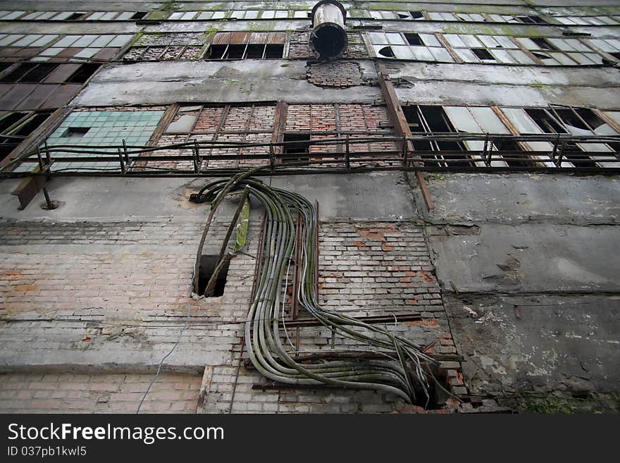 Old abandoned factory brick wall and windows with broken glass. Old abandoned factory brick wall and windows with broken glass