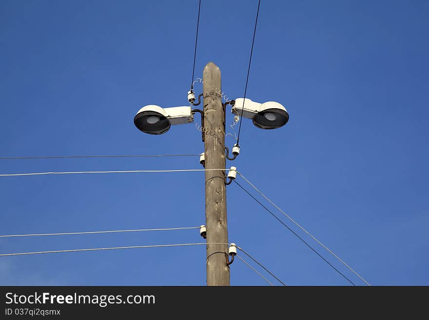 Street lighting. Village. Against the blue sky