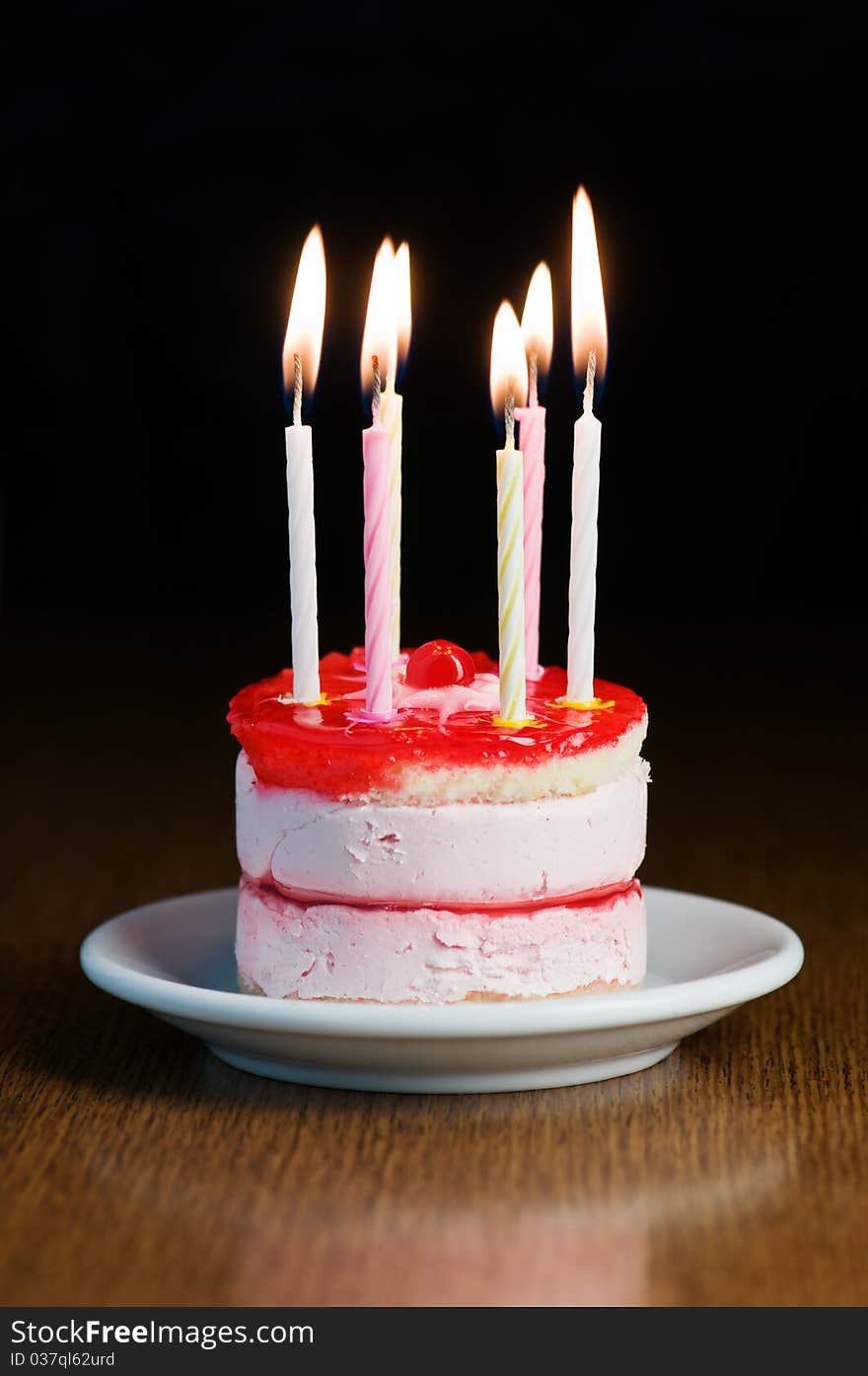 Cake with candle on wood table