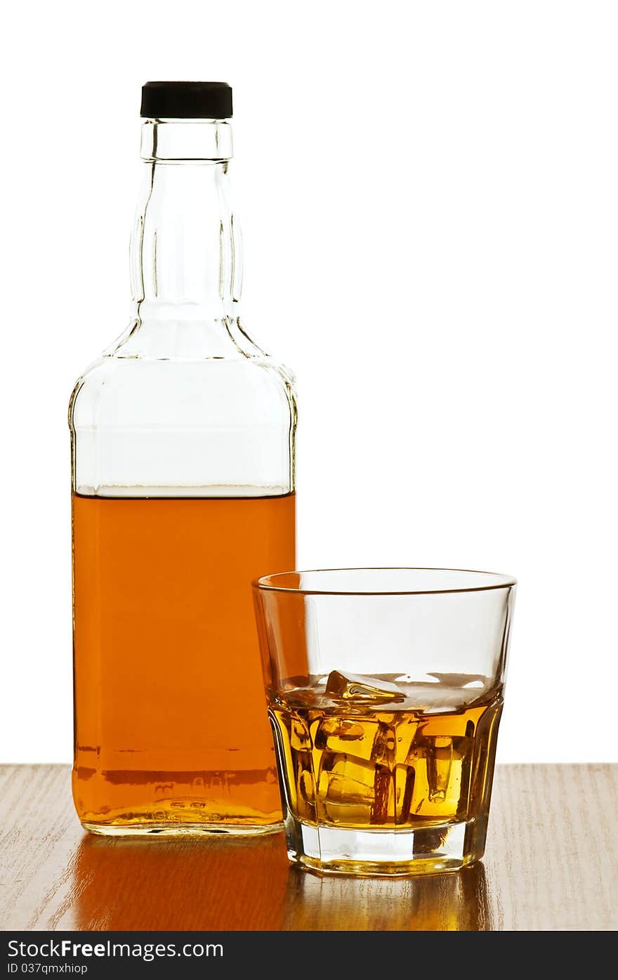 Whiskey bottle with glass isolated