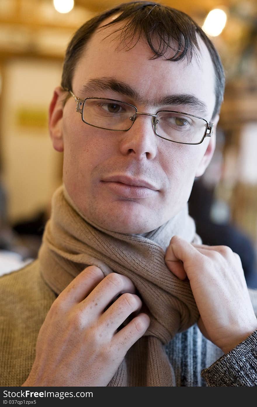 Portrait Of Adult Man Holding His Scarf