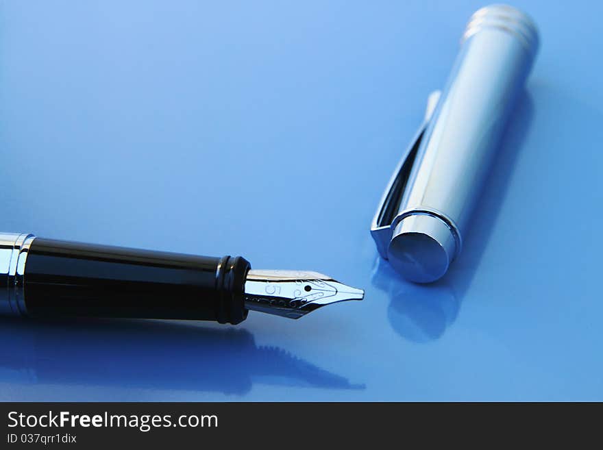 Fountain pen on a light blue background