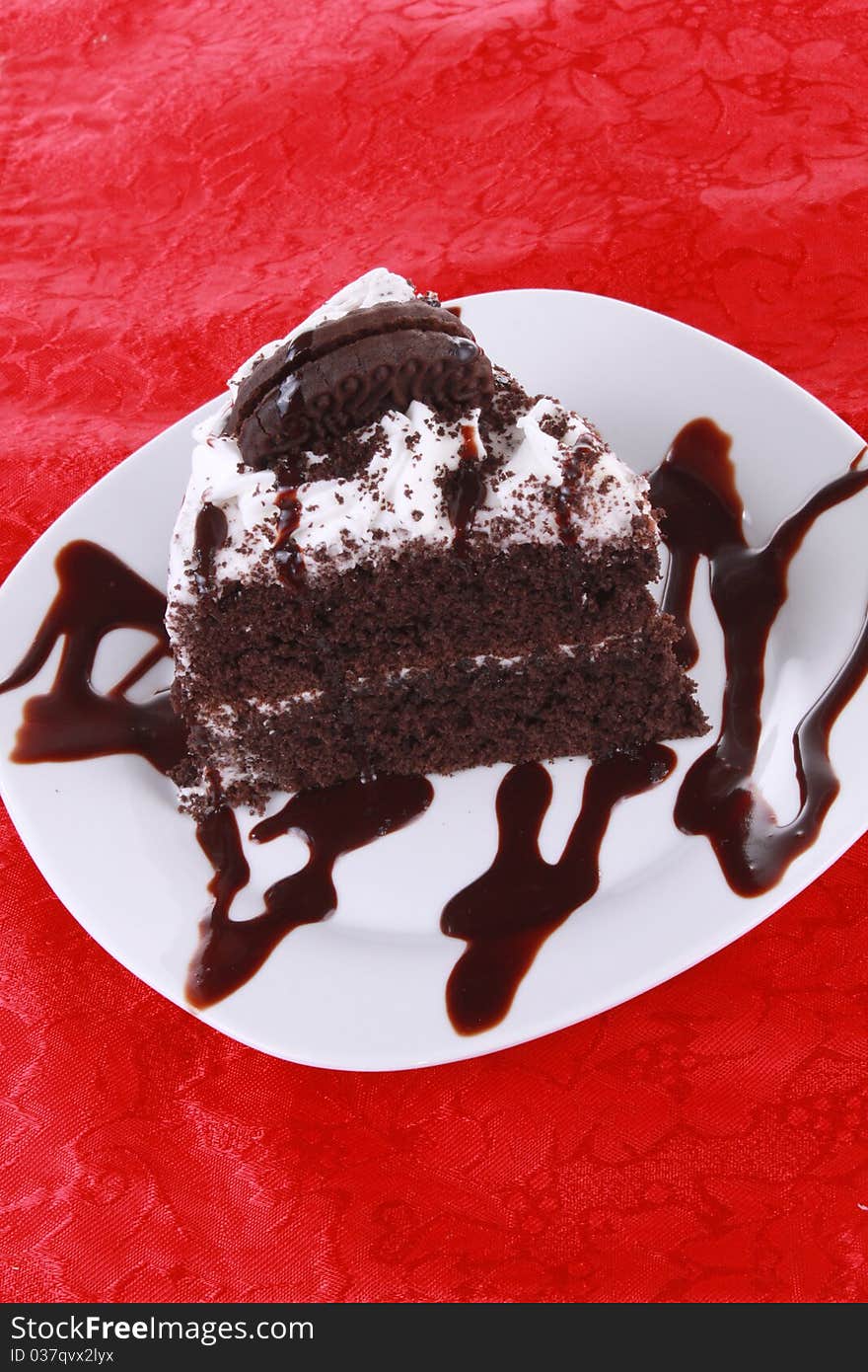 Chocolate cake on bright red tablecloth