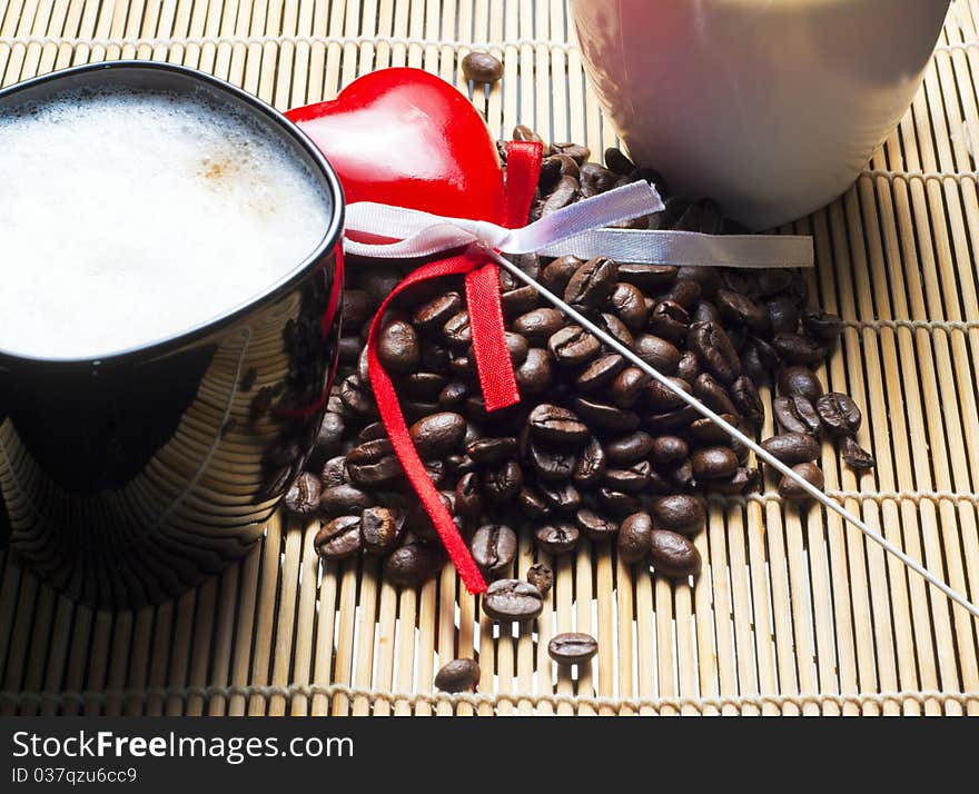 Two coffee cups, heart and beans close shot. Two coffee cups, heart and beans close shot