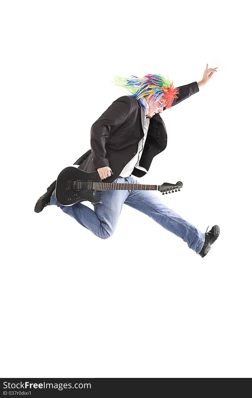 Young guy jumping with guitar