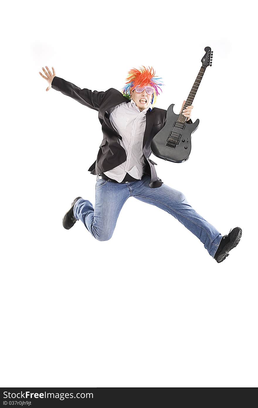 Young guy jumping with guitar