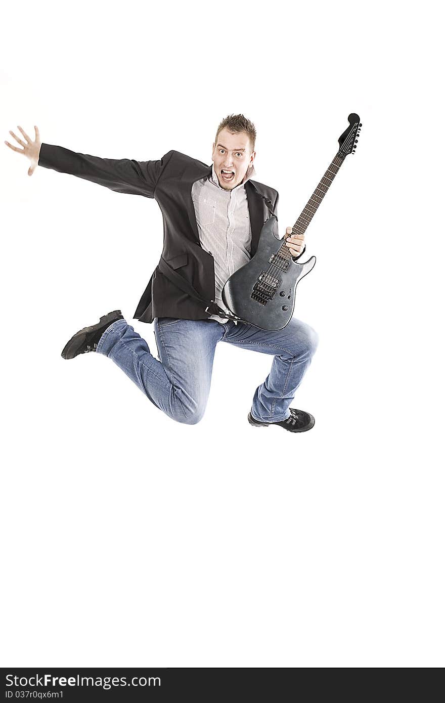 Young guy jumping with guitar