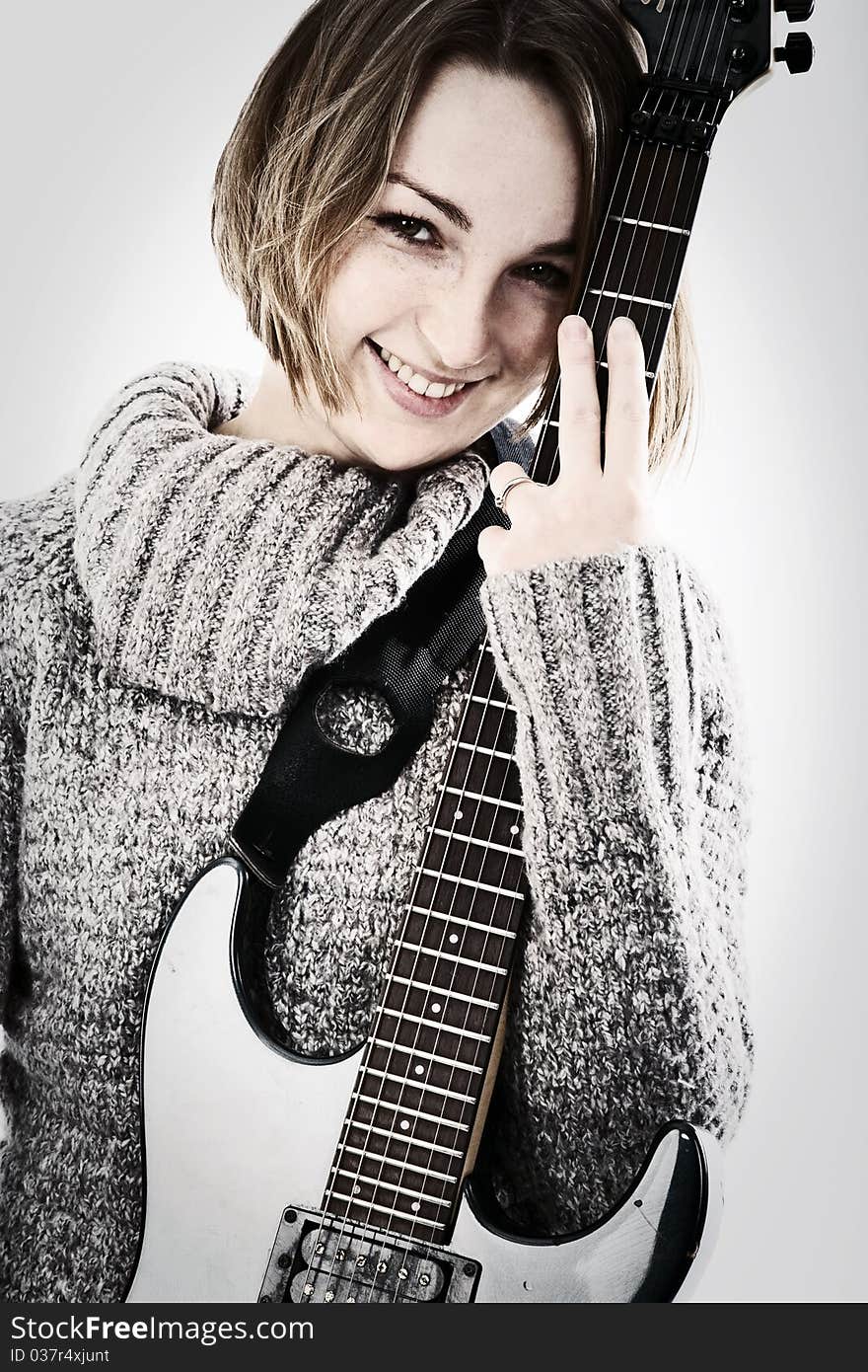 Portrait of a pretty young woman with guitar