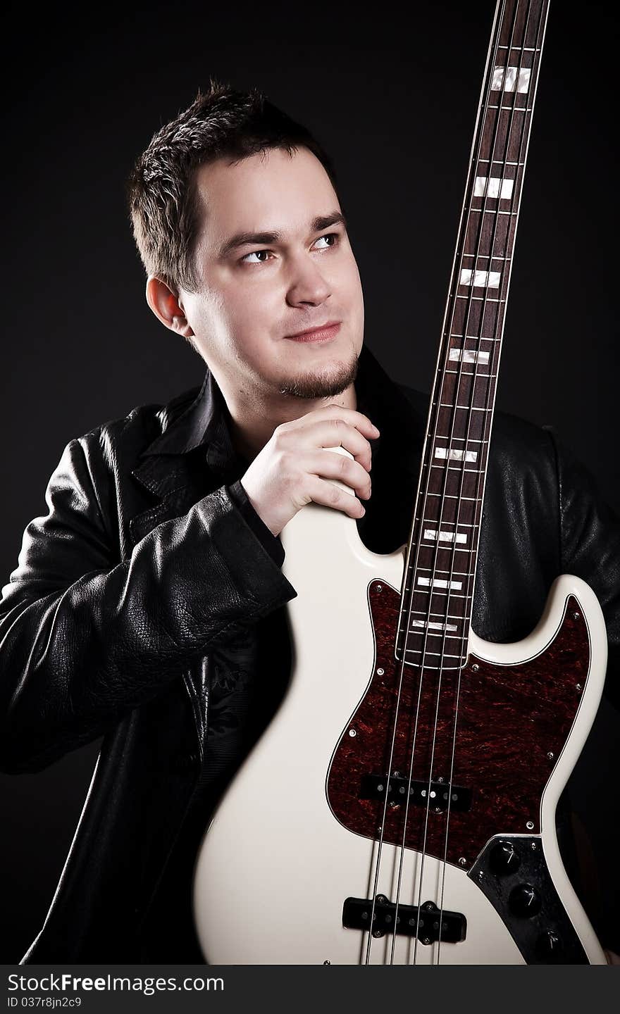 Portrait of the guitarist on a black background