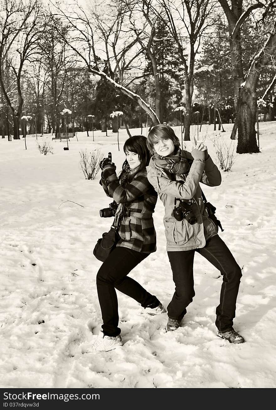 Two girls photographers having fun in the park