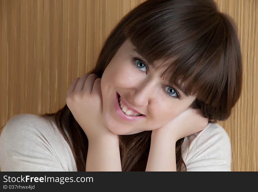 The young girl smiles having lifted hands to the person