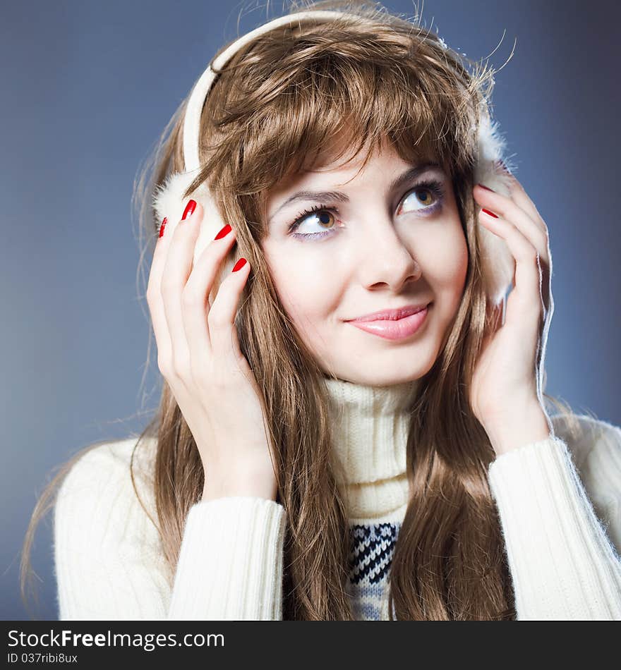 Young beautiful girl rejoices to snow, On a dark blue background