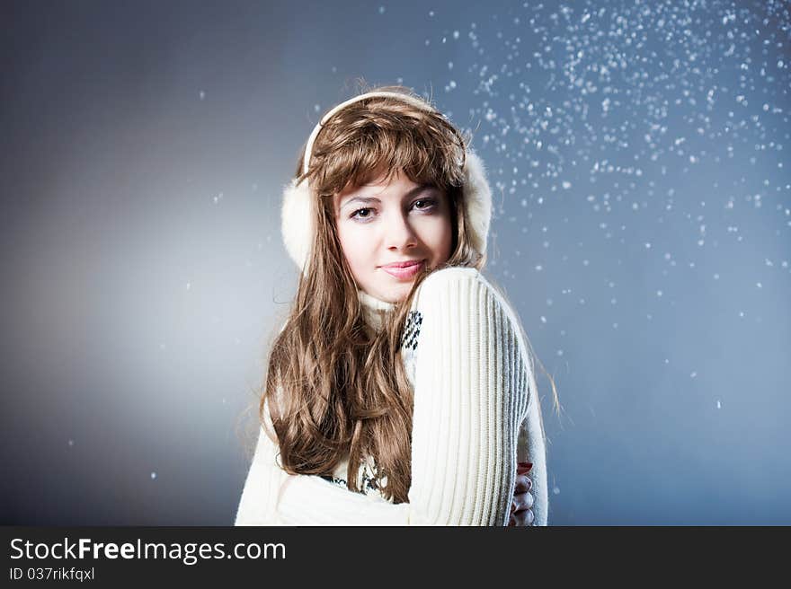 Young beautiful girl rejoices to snow, On a dark blue background