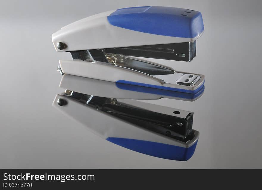 Stapler on a reflective metal