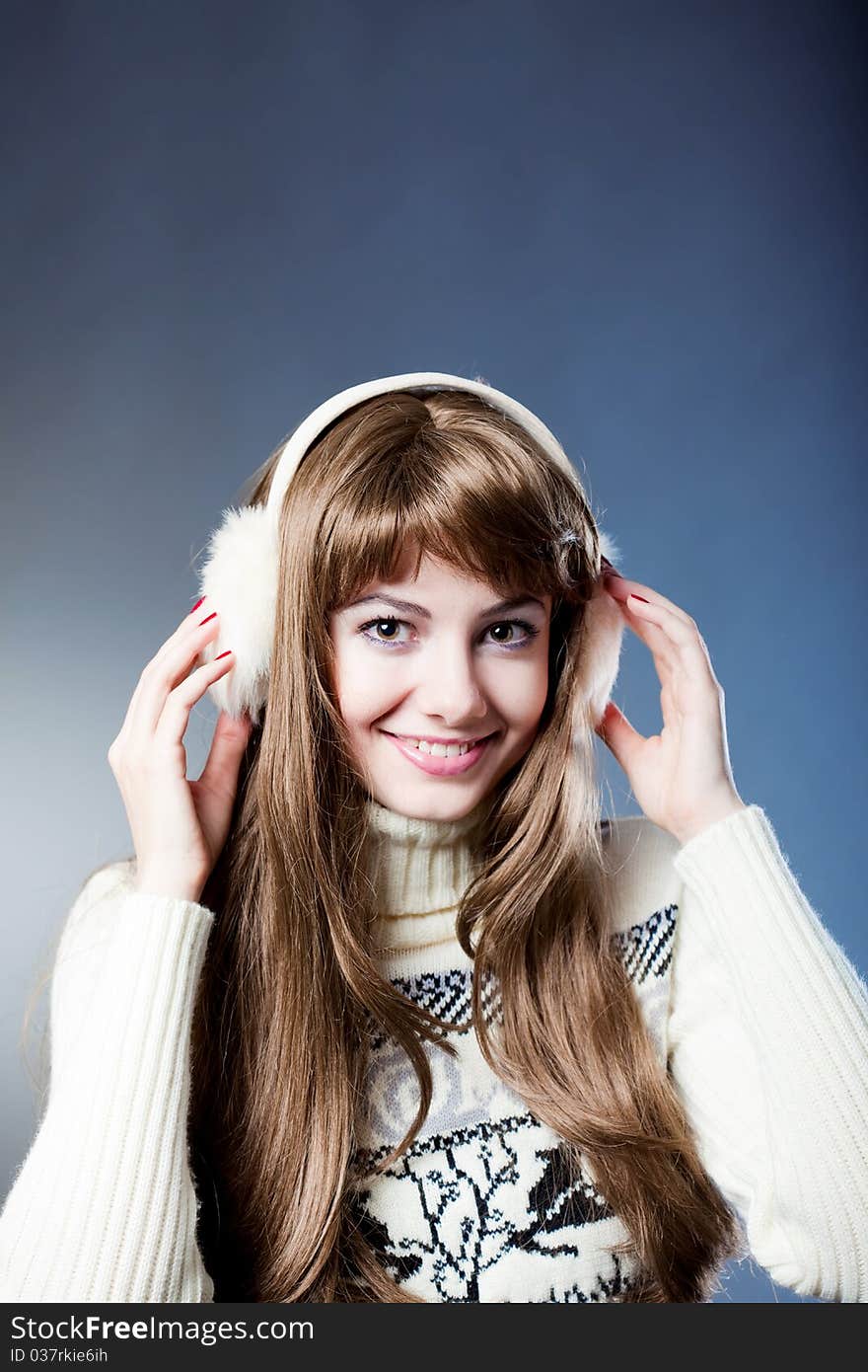 Young beautiful girl rejoices to snow, On a dark blue background